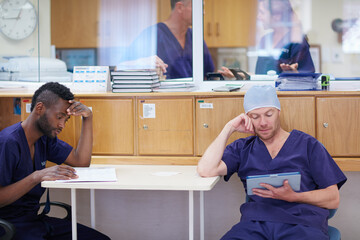 Break room, doctors or reading tablet for operation preparation, procedure refresh or review steps. Surgeon, digital textbook or people with tech to research surgical info, medical record or hospital