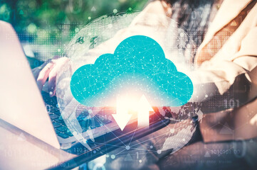 Cloud Computing Data Synchronization Concept, A person working on laptop with glowing digital cloud icon overlay, symbolizing cloud computing, data upload and download, and global digital connectivity