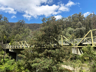 Mountain forest bridge and weather clouds during the Summer