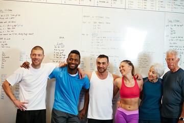 Happy, whiteboard and people in gym for fitness, workout or training planning together for class. Smile, wellness and group of athlete friends for exercise schedule in morning in sports center.
