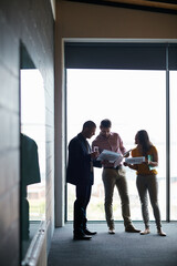 Fototapeta premium Documents, happy group and business people planning in office, advertising proposal or idea. Paperwork, talk and marketing team in boardroom for campaign meeting, brainstorming or brand strategy