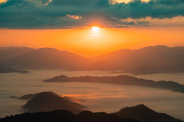 Breathtaking Sunrise Over Misty Mountains and Valleys, Showcasing a Tranquil Landscape of Nature's Beauty at Dawn with Vibrant Colors and Soft Clouds