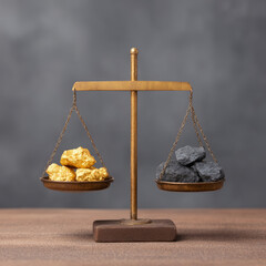 Gold nugget balance scale black rock comparison value metal mineral precious weight trade. Gold nugget balance scale black rock comparison value metal mineral precious weight trade concept wooden