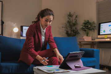 Professional woman working late on financial documents at home