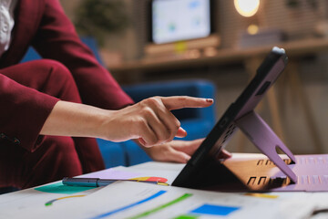 Businesswoman working with tablet analyzing financial data
