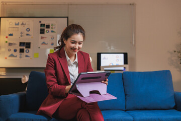 Young businesswoman using digital tablet working late at office