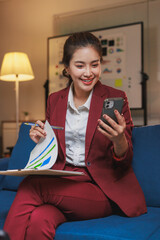 Woman smiling using smartphone for remote business meeting