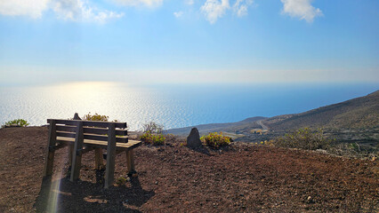 Wooden bench offering panoramic view of the Atlantic Ocean, Valverde, Island El Hierro, Canary Islands, Spain, Europe. © Iryna Shpulak