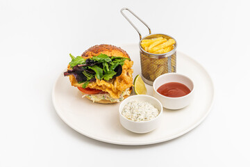 Crispy fried chicken burger served with fries and creamy dips