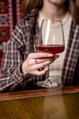 Woman holding elegant glass of red wine