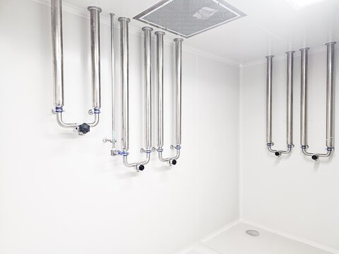 Cleanroom with stainless steel piping systems and ceiling-mounted ventilation.
