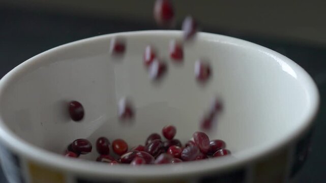 Red adzuki mung beans falling in slow motion