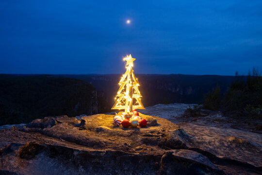 Christmas Tree fairy lights cliff top in the mountains