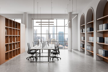Modern open office interior with minimalist furniture, large windows, bookshelves, and cityscape view in daylight setting. 3D Rendering © ImageFlow