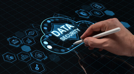 Hand drawing holographic data security interface with stylus on digital screen representing future technology and cybersecurity concept.
