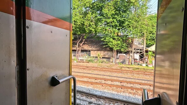 Moving Train View of Bangkok Railway Tracks and Buildings