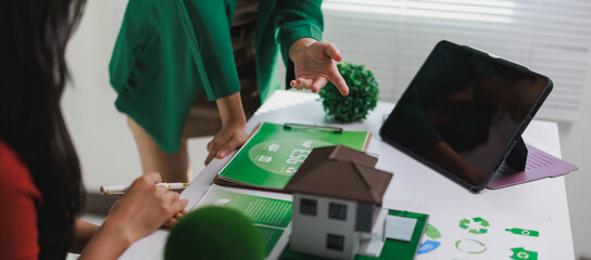 People discussing sustainable green energy home solutions © Phimwilai