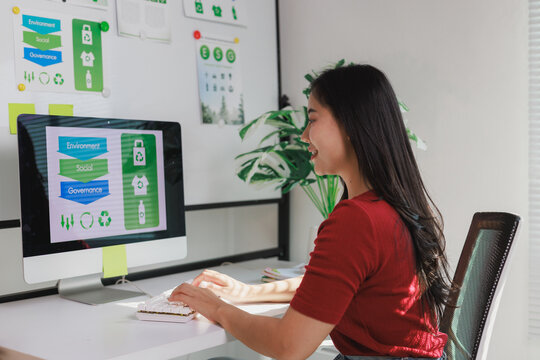 Woman analyzing esg sustainability report on computer - Powered by Adobe