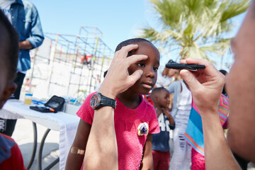 Doctor, child and pupil torch with volunteer hands for community outreach, test or accountability for wellness. People, girl and pediatrician with eye care, charity or social responsibility at park