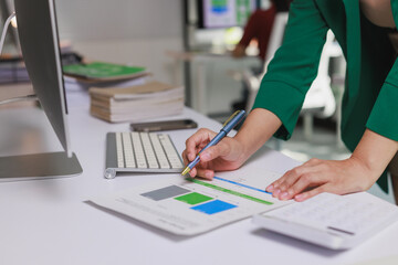 Businesswoman analyzing corporate financial data in office