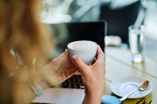 cappuccino laptop cafe business drink table cup computer technology morning espresso cappuccino mug closeup office breakfast caffeine work desk - Powered by Adobe