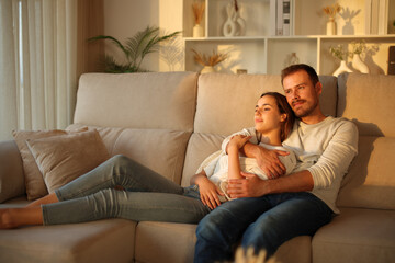 Fototapeta premium Couple in love relaxing at sunset at home