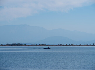 Tourlida, Greece. October 27, 2025: Fishermen and fishing boats in the fishing village of Tullida in Greece