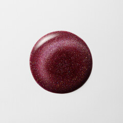 Glitter Nail Polish Drop on White Surface