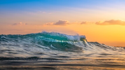 A beautiful view capturing an ocean wave cresting under a vibrant orange and blue sunset sky providing a peaceful seascape scene.