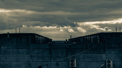 Abandoned Rooftop at Dusk. Moody storm clouds gather over an industrial rooftop, evoking solitude and urban decay
