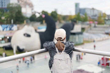 Happy woman traveler travel in Dujiangyan city. Tourist sightseeing Yangtianwo Square and Guanxian...