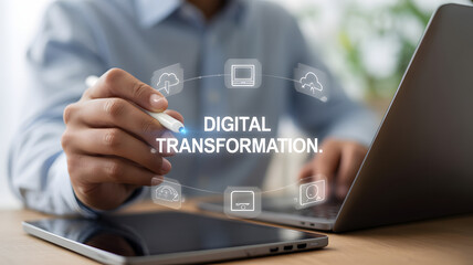 Businessman interacting with digital transformation concept icons on a virtual screen, using a stylus near a laptop and tablet on a desk, isolated on white background