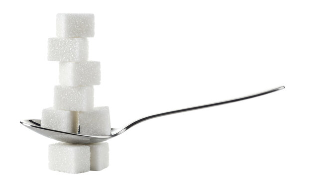 A precarious stack of refined white sugar cubes on a gleaming silver dessert spoon, isolated against a transparent studio background with copy space, concept of delicate balance and excess