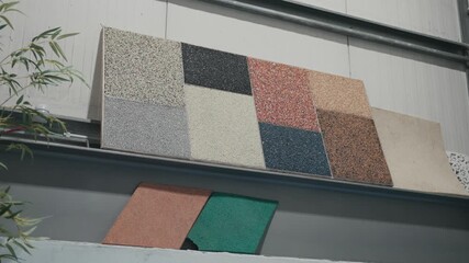 Assorted textured rubber sample squares mounted on panel