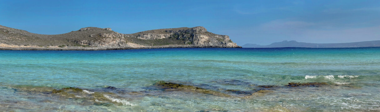 beautiful turquoise blue sea in Simos beach with sandy hill background in  the island Elafonisos in peloponnese, greece