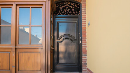 Antique wooden entrance door in an old stone wall building