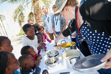 Food drive, dish and children outdoor for community service, charity or volunteering for contribution. Meal, help and kids with lunch in nature for ngo organization for welfare with giving back.