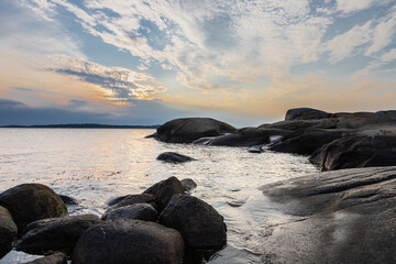 Colourful sunset over the Baltic Sea and the Swedish archipelago near Gothenburg seen from the village of Vastra Frolunda, which is characterised by beautiful scenery, amazing shaped boulders and unto