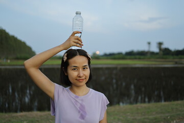 Woman drinking water after exercise.