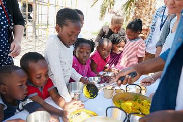 Food drive, dish and kids outdoor for community service, charity or volunteering for contribution. Meal, help and children with lunch in nature for ngo organization for welfare with giving back.