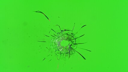 Freeze Motion Shot of Glass Shattered by a Bullet from a Pistol on Green Screen Background
