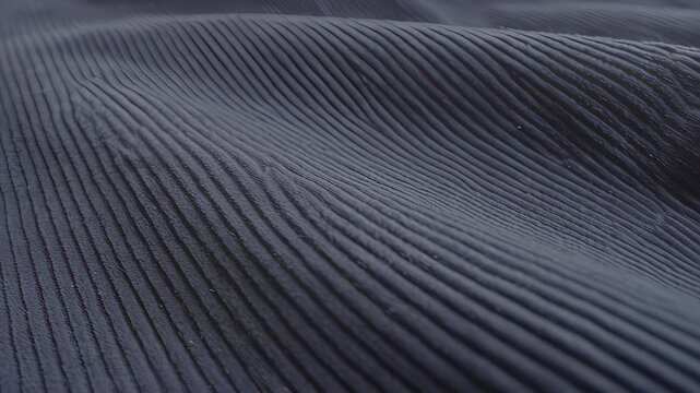 Close up of dark blue fabric with parallel ribbed texture