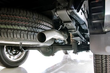 Exhaust pipe, spare tire and suspension of pickup car