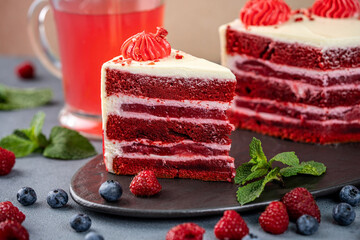 Red berry layer cake slice with cream frosting