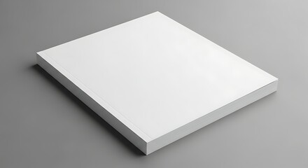 A stack of blank white paper on a neutral gray surface, angled for a slightly elevated view, creating a simple, clean look