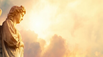 Fototapeta premium Statue of angel against cloudy sky during sunset