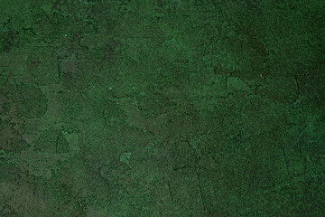 Dark green textured wall with aged rough plaster and grunge pattern