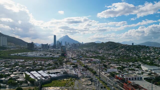 Panoramic view of Monterrey City with Sierra Las Mitras in the background and busy car traffic