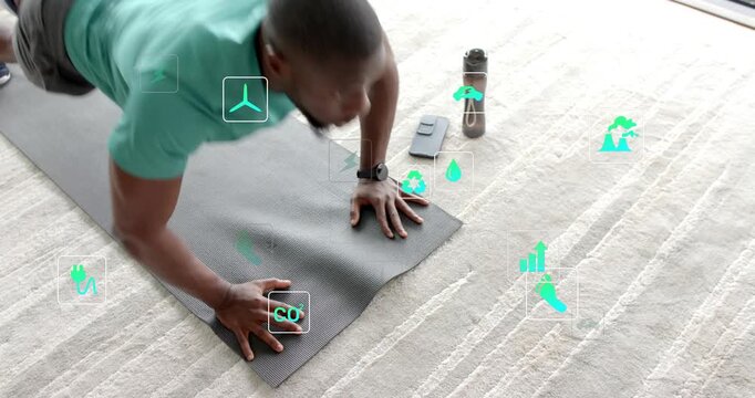 Man starting plank and doing pushups on carpet, fitness metrics tracking workout near water bottle