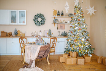 Cozy kitchen decorated for winter holidays with a lit Christmas tree and festive table setting.